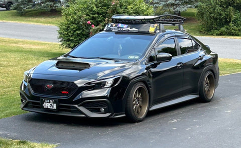 front view of black Subaru WRX parked on driveway