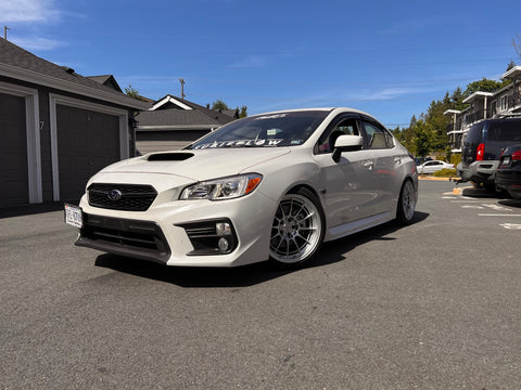 front view of white subaru in parking lot